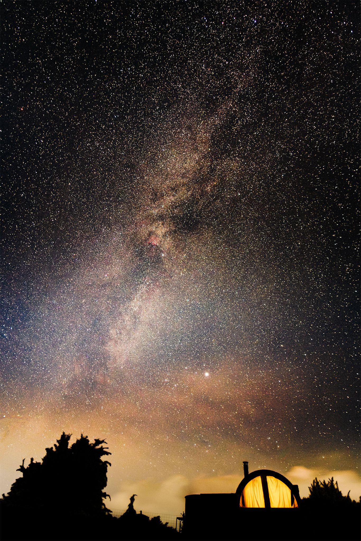 Milky Way galaxy over log cabin in Snowdonia (Eryri) Wales